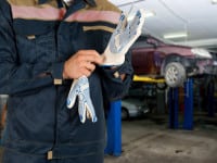 Auto mechanics closeup standing in his workshop